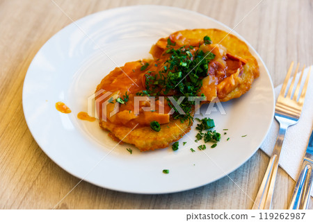 Belarusian draniki with vegetable and sausage stew 119262987