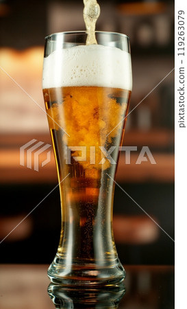 Close-up of beer pouring into pint , freeze motion. 119263079
