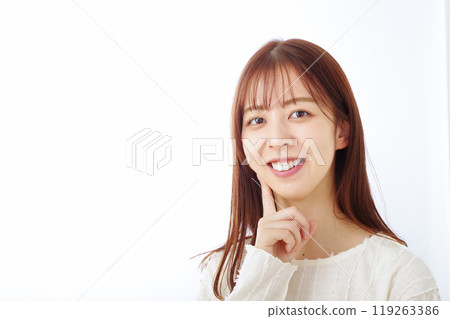 A woman pointing at her mouth with a smile 119263386