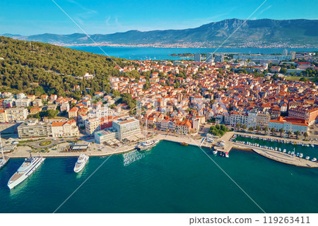 Aerial view of Split, Croatia. Cityscape of coastal touristic city with harbor with mountains in background. Old town with historical red roof tiled buildings near Adriatic Sea 119263411