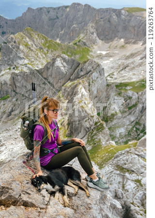 Female Hiker with Dog Sitting on Mountain Top Female Hiker with Dog Sitting on Mountain Top 119263764