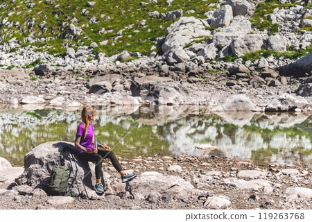 Female Mountain Traveler Resting During Hiking 119263768