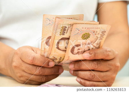 Asian woman counting Thai baht banknote money, investment economy, accounting business and banking. 119263813