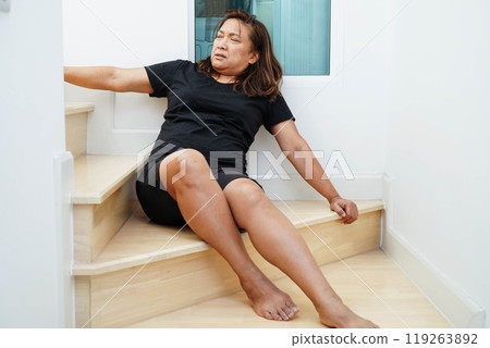 Asian lady woman injury from falling down on slippery surfaces stairs at home. Asian lady woman injury from falling down on slippery surfaces stairs at home. 119263892