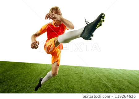 Footballer delivers high kick, with perfect technique and focus on ball. His posture highlights balance and precision needed for such move. 119264626