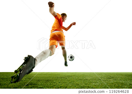 Perfect stride. Soccer athlete charges forward, fully immersed in game. His determination and athleticism evident in every step. 119264628