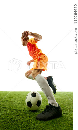 Swift footwork in action. Football athlete mid-sprint, advancing ball down field with determination and speed, aiming for goal-scoring opportunity. 119264630