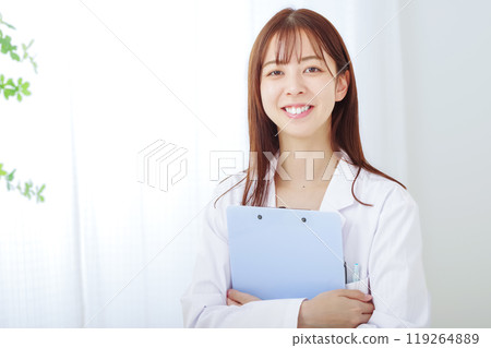 Young woman in white coat with white background Young woman in white coat with white background 119264889