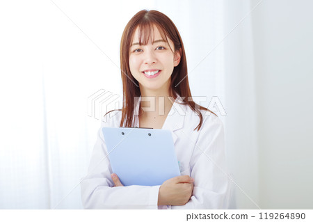 Young woman in white coat with white background Young woman in white coat with white background 119264890