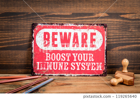Boost your immune system. Beware sign with text on a wooden texture office table Boost your immune system. Beware sign with text on a wooden texture office table 119265640