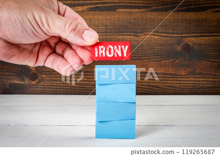 Irony Concept. Blue wooden blocks in a pile on a white wooden table 119265687