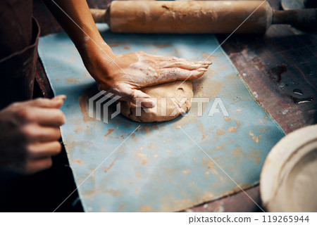 Female potter sculpts from clay at her workshop close-up 119265944