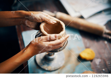 Female artist sculpts crafts with ceramic clay at her creative workshop 119265946