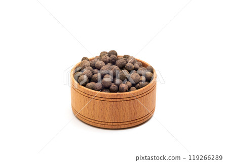 Black pepper in a wooden bowl isolated on white background. Black peppercorns, Healthy eating 119266289