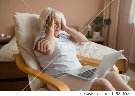 Headache older retired woman getting financial problems, troubles with difficult financial application for payment, finding mistakes, overspending, bankruptcy risk 119266582