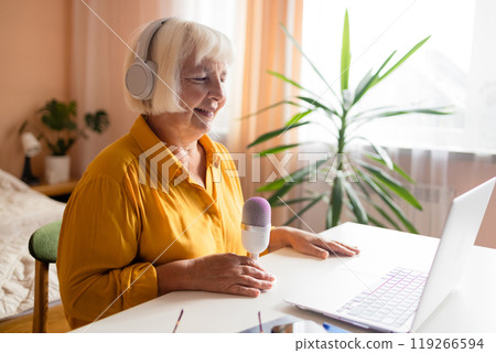 Female podcaster use smartphone and speaking with audience on microphone to recording video podcast. Female podcaster use smartphone and speaking with audience on microphone to recording video podcast. 119266594