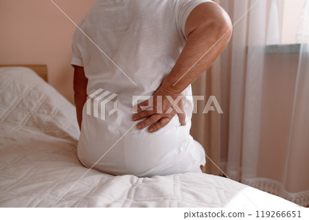 Mature senior lady feeling muscles pain attack, holding back, having problem with standing up. Elderly woman suffering from chronic backache, kidney disease, lumbar osteochondrosis, inflammation 119266651