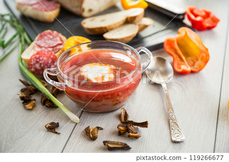 Lenten borscht with dried mushrooms and vegetables, on a light wooden table Lenten borscht with dried mushrooms and vegetables, on a light wooden table 119266677