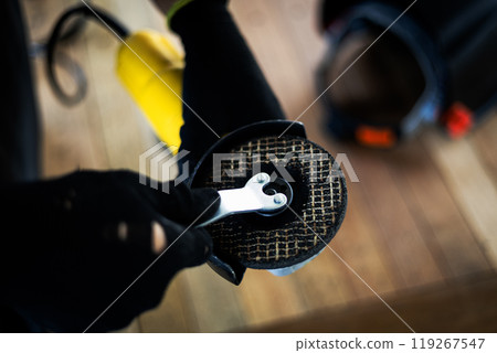 Worker is using angle grinder. Hand tool. 119267547