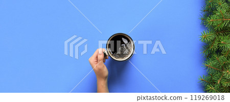 Minimalistic style woman hand holding a mug of coffee on purple background. Flat lay, top view 119269018