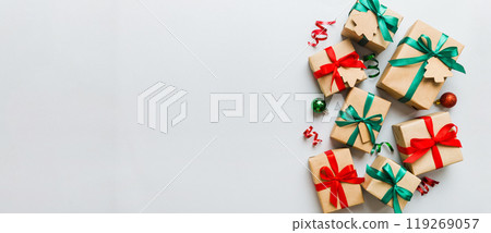 wrapped christmas or other holiday handmade present in paper with colored ribbon. Present box, decoration of gift on colourfull table, top view with copy space wrapped christmas or other holiday handmade present in paper with colored ribbon. Present box, decoration of gift on colourfull table, top view with copy space 119269057