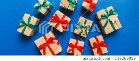 Colored craft gift boxes with colorful ribbons on colored background. Collection of Christmas present boxes Colored craft gift boxes with colorful ribbons on colored background. Collection of Christmas present boxes 119269059
