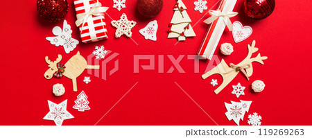 Top view of Christmas decorations on red background. New Year holiday concept with copy space 119269263