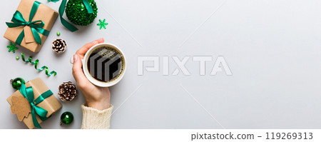 Woman holding cup of coffee. Woman hands holding a mug with hot coffee. Winter and Christmas time concept Woman holding cup of coffee. Woman hands holding a mug with hot coffee. Winter and Christmas time concept 119269313