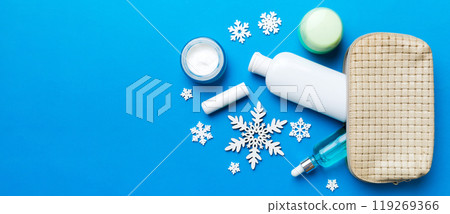 Christmas flat lay with makeup cosmetic products in cosmetic bag on colored background. Top view New year Beauty concept Christmas flat lay with makeup cosmetic products in cosmetic bag on colored background. Top view New year Beauty concept 119269366