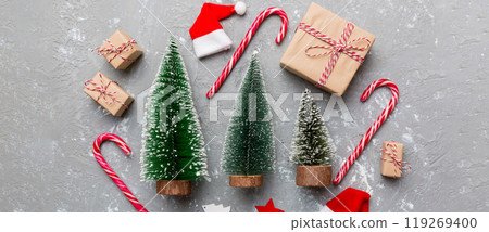 Flat lay composition with christmas trees on color background. Top view with copy space Flat lay composition with christmas trees on color background. Top view with copy space 119269400