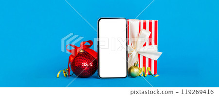 Digital phone mock up with rustic Christmas decorations for app presentation with empty space for you design. Christmas online shopping concept. Tablet with copy space on colored background 119269416
