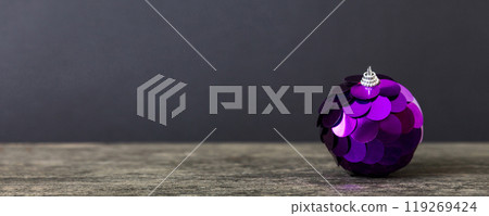 Christmas ball on colored background. decoration bauble with ribbon bow with copy space 119269424