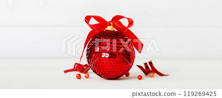 Christmas ball on colored background. decoration bauble with ribbon bow with copy space 119269425