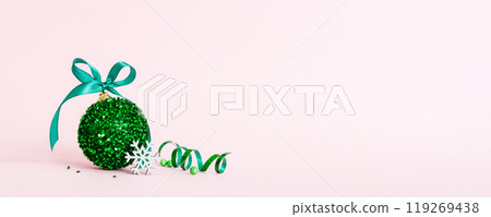 Christmas ball on colored background. decoration bauble with ribbon bow with copy space Christmas ball on colored background. decoration bauble with ribbon bow with copy space 119269438