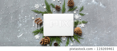 Flat lay Christmas composition. square Paper blank, pine tree branches, christmas decorations on Colored background. Top view, copy space for text Flat lay Christmas composition. square Paper blank, pine tree branches, christmas decorations on Colored background. Top view, copy space for text 119269461