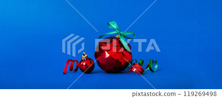 Christmas ball on colored background. decoration bauble with ribbon bow with copy space 119269498