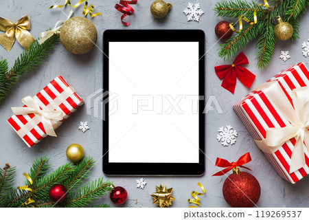 Digital tablet mock up with rustic Christmas decorations for app presentation top view with empty space for you design. Christmas online shopping concept. Tablet with copy space on colored background 119269537
