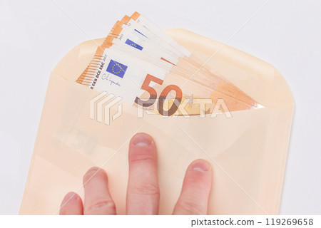 Hand Holds An Orange Paper Envelope with Stack of 50-Euro Banknotes Inside 119269658