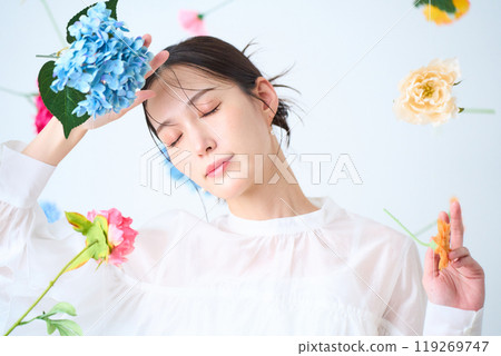 A woman surrounded by colorful flowers - fantasy 119269747