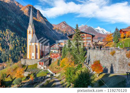 Astonishing autumn landscape  at Heiligenblut with St Vincent Church near Grossglockner mount . 119270120