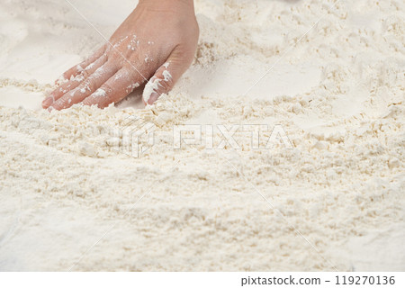Baker working with white wheat flour, hands close-up. Baker working with white wheat flour, hands close-up. 119270136