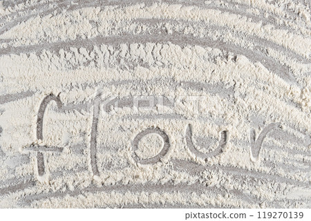 Text flour written on white wheat flour top view. 119270139