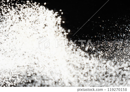 Abstract black and white background of pouring flour, space for text 119270158