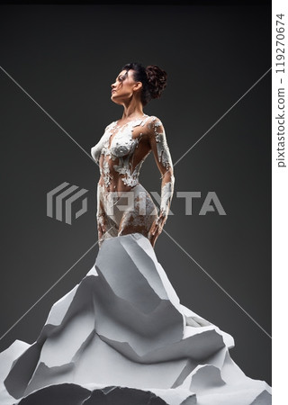 Woman Covered in White Paint Standing on a Sculptural Form Woman Covered in White Paint Standing on a Sculptural Form 119270674
