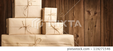 An arrangement of Stacked Rustic Gift Boxes set against a beautiful wooden wall 119271546