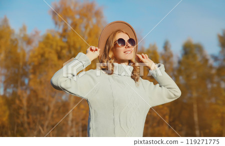 Happy stylish smiling woman in autumn park, joyful girl enjoying warm sunny weather, fall season Happy stylish smiling woman in autumn park, joyful girl enjoying warm sunny weather, fall season 119271775