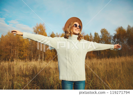 Stylish modern happy young woman having fun dancing, fashionable girl smiling outdoors, autumn park Stylish modern happy young woman having fun dancing, fashionable girl smiling outdoors, autumn park 119271794