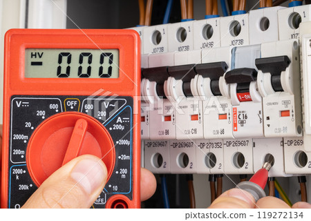 Electrician Testing Circuit Breaker with Multimeter Electrician Testing Circuit Breaker with Multimeter 119272134