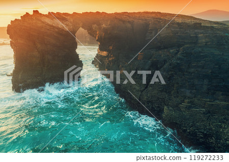 Arch in the rock. Seascape in the morning. Rocky sea coast at sunrise. Beach Playa de Las Catedrales in Ribadeo. Galicia Spain Europe 119272233