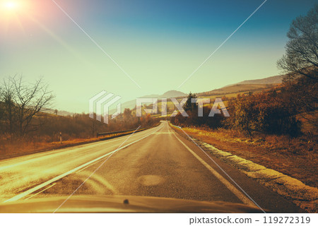 View of the highway to mountains during sunrise in autumn. Carpathian mountains. Ukraine View of the highway to mountains during sunrise in autumn. Carpathian mountains. Ukraine 119272319